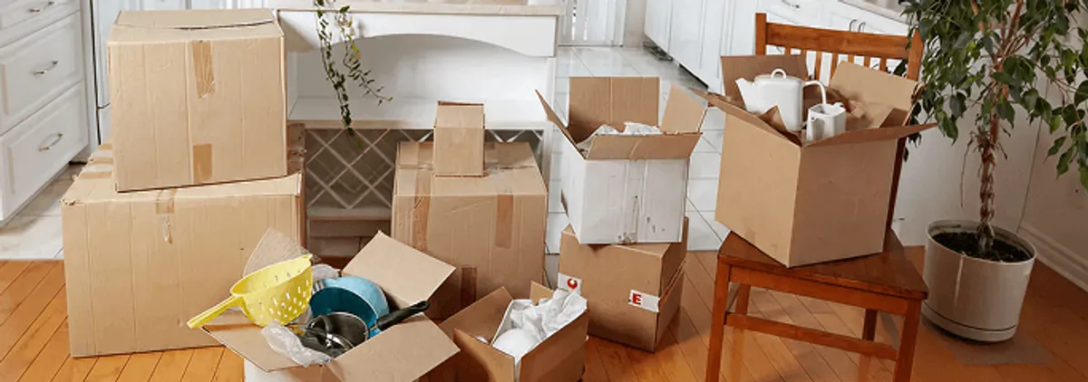 Packed moving boxes and household items in a kitchen before move-out or move-in cleaning, Madison, WI.